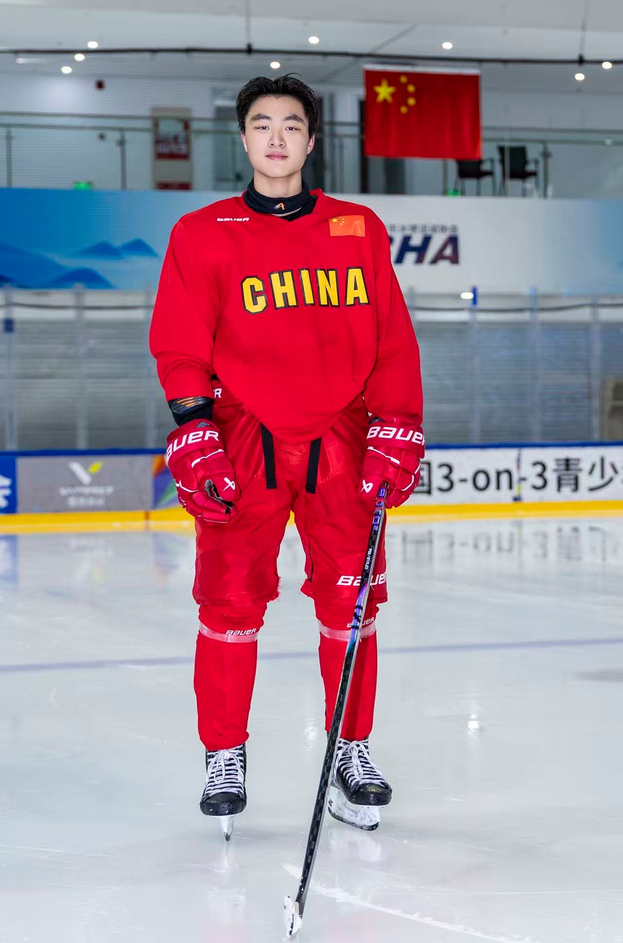Frank in a red hockey jersey at the rink